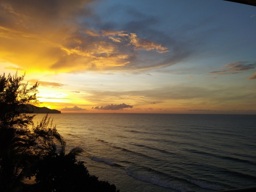 Dramatic sunset over the sea viewed from the villa pool