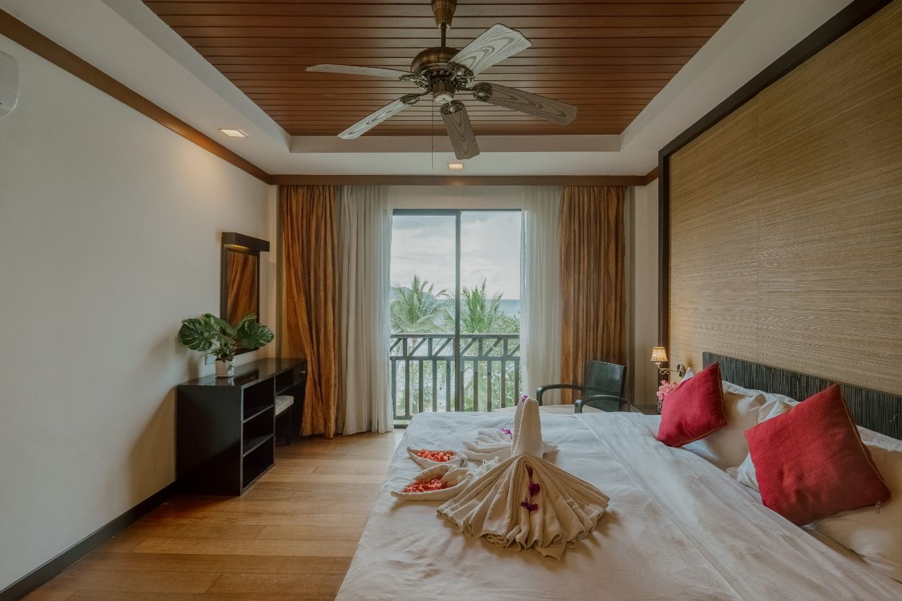 Sunset Spa Suite bedroom with sea-view balcony